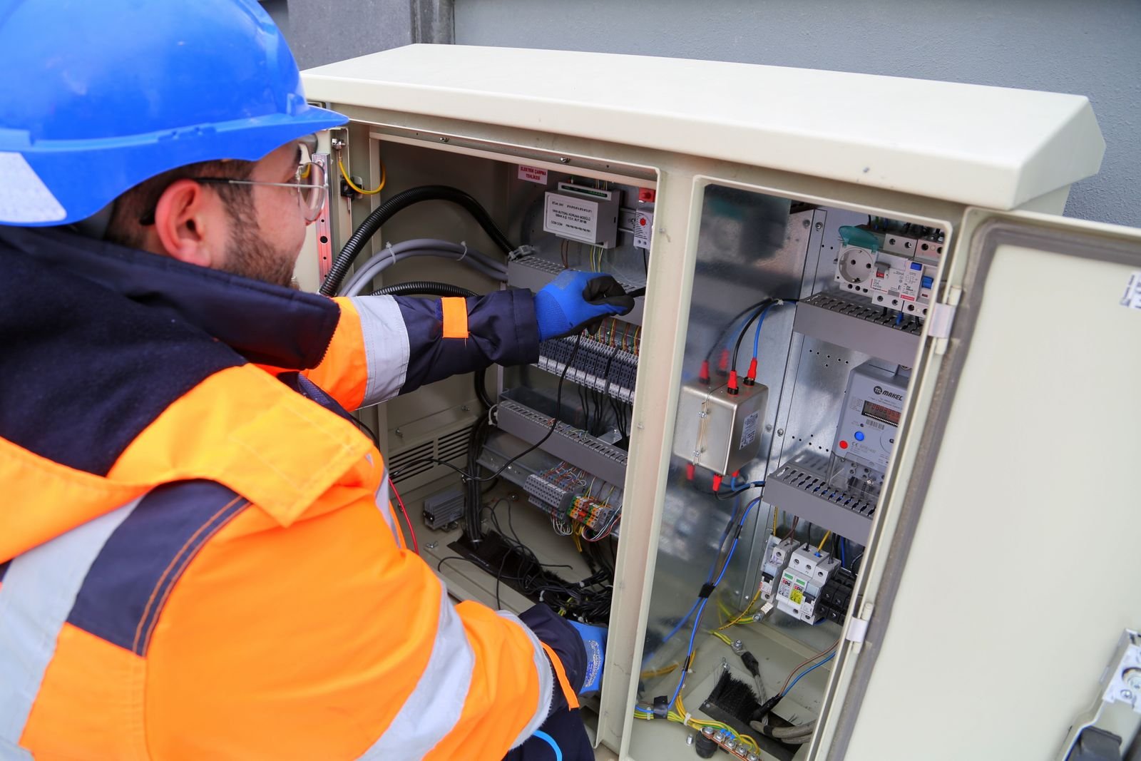 Electrician working at a fuse box